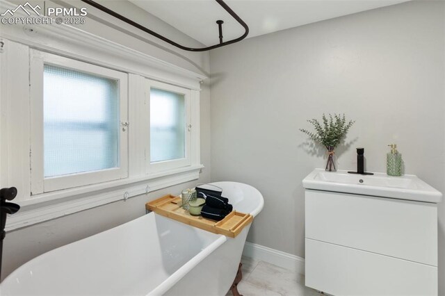 122 E Jefferson St, Colorado Springs, CO 80907 - full bathroom featuring a soaking tub, vanity, and marble finish flooring