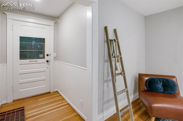 122 E Jefferson St, Colorado Springs, CO 80907 - entryway featuring light wood-style floors and a wainscoted wall