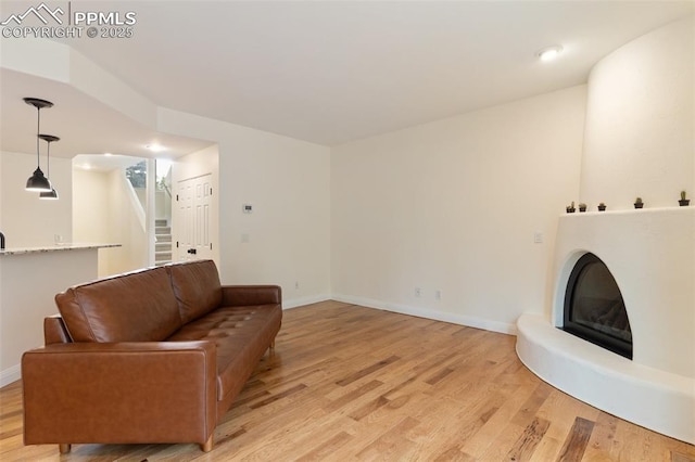 3219 W Pikes Peak Ave, Colorado Springs, CO 80904 - living area with light wood-type flooring, stairs, recessed lighting, and a fireplace