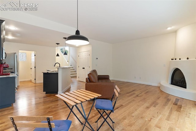 3219 W Pikes Peak Ave, Colorado Springs, CO 80904 - living room featuring stairway and light wood-style floors