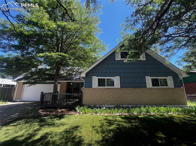135 Judson St, Colorado Springs, CO 80911 - view of front of property featuring brick siding, driveway, a garage, and a front yard
