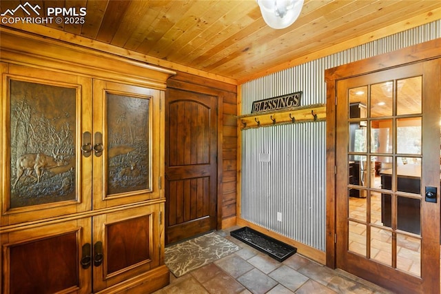 101 Daniwood Grv, Florissant, CO 80816 - entrance foyer featuring wood walls, wood ceiling, stone finish floors, and french doors