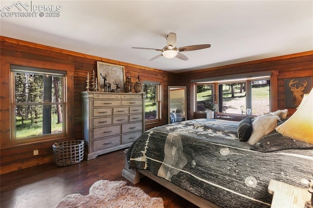 101 Daniwood Grv, Florissant, CO 80816 - bedroom with multiple windows, dark wood finished floors, wood walls, and ceiling fan