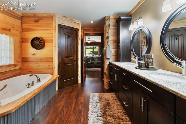 101 Daniwood Grv, Florissant, CO 80816 - full bathroom with wood finished floors, ensuite bath, vanity, and a whirlpool tub