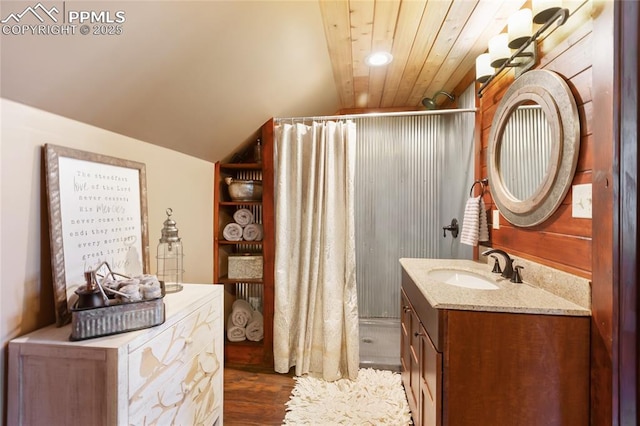 101 Daniwood Grv, Florissant, CO 80816 - full bath with vanity, a shower with shower curtain, wood finished floors, vaulted ceiling, and recessed lighting