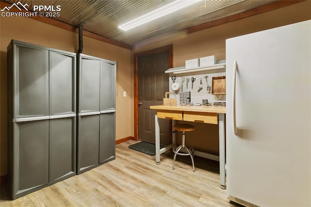 101 Daniwood Grv, Florissant, CO 80816 - kitchen with freestanding refrigerator, light wood-type flooring, and tasteful backsplash