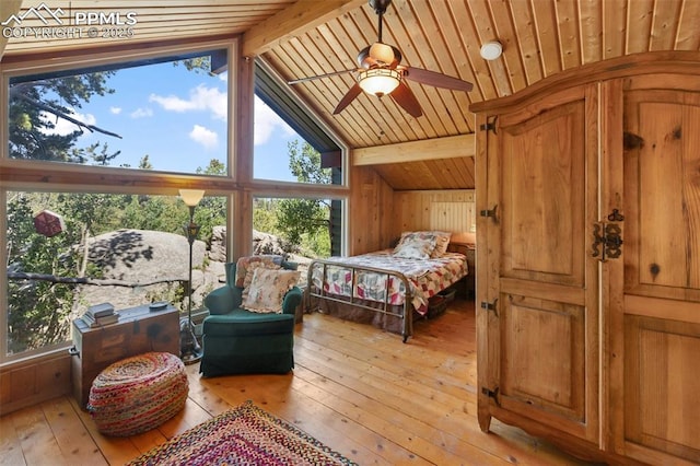 47 Red Cloud Rd, Woodland Park, CO 80863 - bedroom with light wood-type flooring, multiple windows, wood ceiling, and wooden walls