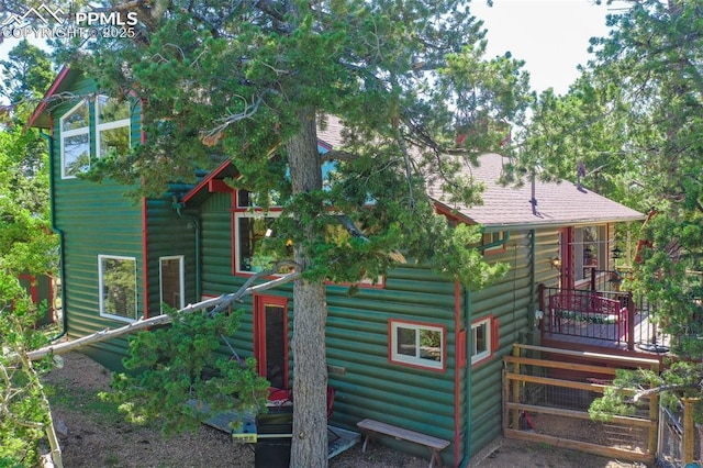 47 Red Cloud Rd, Woodland Park, CO 80863 - back of house featuring a wooden deck and faux log siding