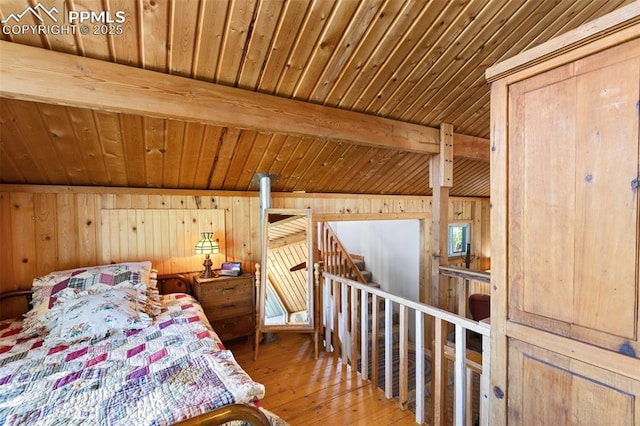 47 Red Cloud Rd, Woodland Park, CO 80863 - bedroom featuring a wood ceiling with exposed beams, wood walls, and hardwood / wood-style flooring