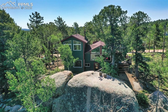 47 Red Cloud Rd, Woodland Park, CO 80863 - rear view of property with a wooded view and a wooden deck