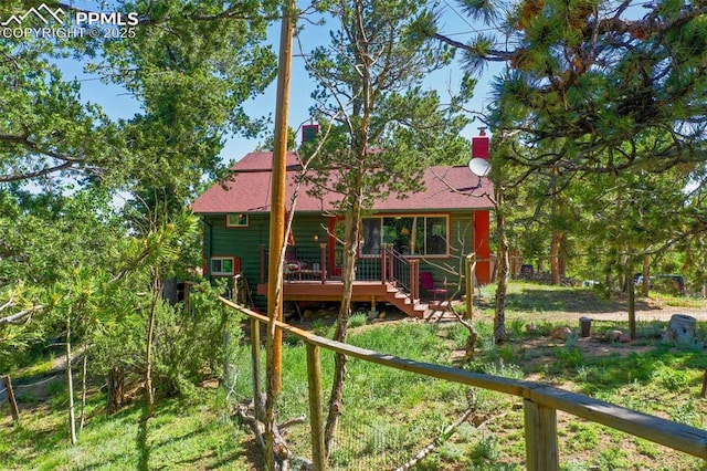 47 Red Cloud Rd, Woodland Park, CO 80863 - back of house with stairway, a wooden deck, and a chimney