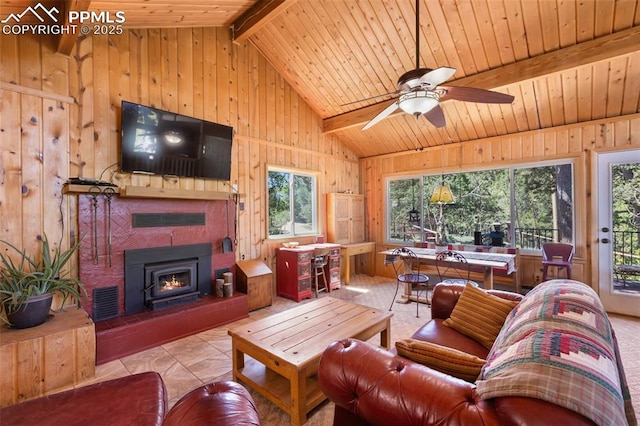 47 Red Cloud Rd, Woodland Park, CO 80863 - living area featuring wood walls, wood ceiling, ceiling fan, tile patterned floors, and a lit fireplace