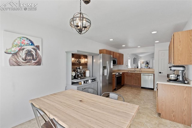 6534 Harvey Ln, Colorado Springs, CO 80923 - kitchen with stainless steel appliances, light countertops, a chandelier, recessed lighting, and decorative light fixtures