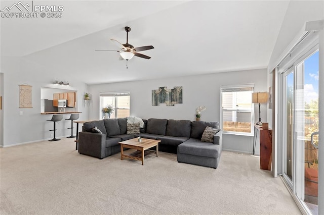 6534 Harvey Ln, Colorado Springs, CO 80923 - living room with light colored carpet, plenty of natural light, a ceiling fan, and lofted ceiling