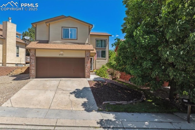 2722 Front Royal Dr, Colorado Springs, CO 80919 - view of front of property with an attached garage, concrete driveway, brick siding, and roof with shingles
