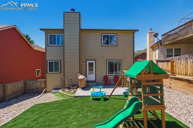 2722 Front Royal Dr, Colorado Springs, CO 80919 - back of property featuring a playground, a chimney, a fenced backyard, and a patio