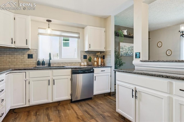 2722 Front Royal Dr, Colorado Springs, CO 80919 - kitchen featuring stainless steel dishwasher, white cabinetry, tasteful backsplash, dark wood-style floors, and decorative light fixtures