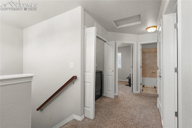 9744 Rubicon Dr, Colorado Springs, CO 80925 - corridor with an upstairs landing, carpet floors, attic access, and washer / clothes dryer