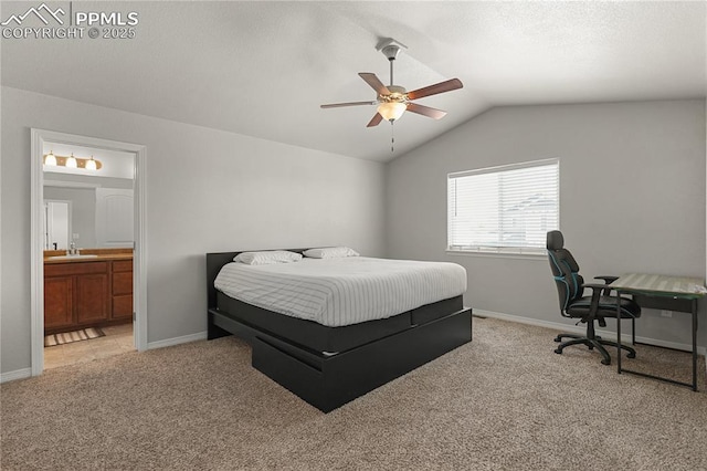 9744 Rubicon Dr, Colorado Springs, CO 80925 - bedroom featuring light carpet, lofted ceiling, ensuite bathroom, a desk, and ceiling fan