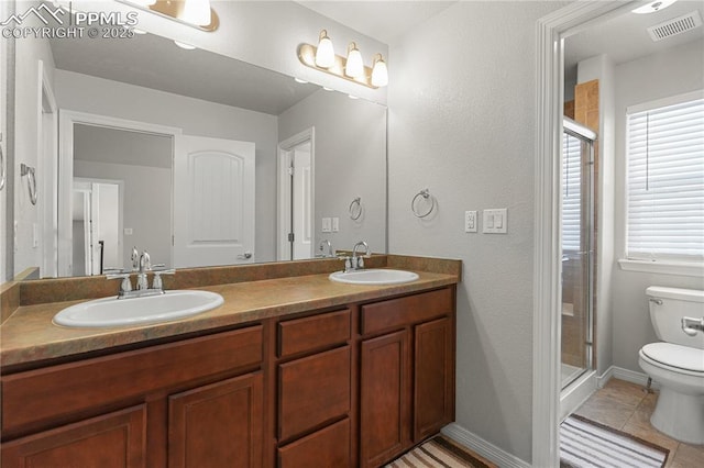 9744 Rubicon Dr, Colorado Springs, CO 80925 - full bath with a shower stall, double vanity, and tile patterned flooring