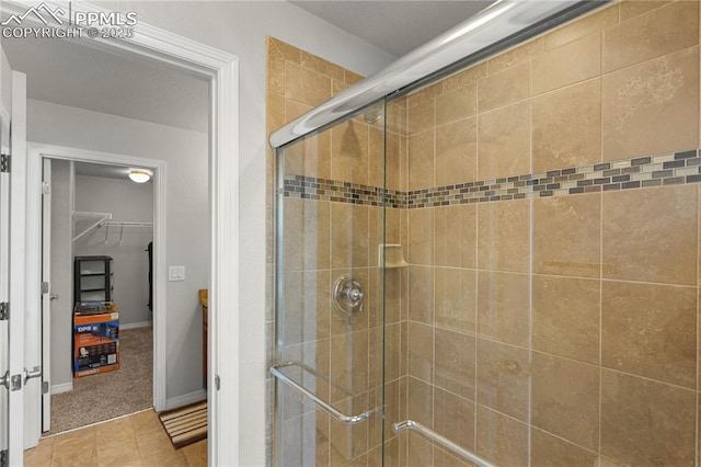 9744 Rubicon Dr, Colorado Springs, CO 80925 - full bathroom featuring a shower stall, a spacious closet, and tile patterned flooring