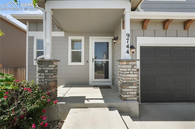 9744 Rubicon Dr, Colorado Springs, CO 80925 - entrance to property featuring stone siding, a garage, and driveway