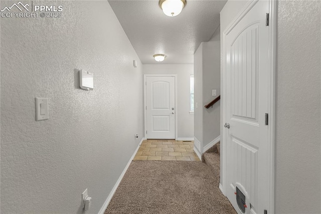 9744 Rubicon Dr, Colorado Springs, CO 80925 - hallway featuring light carpet, a textured wall, light tile patterned flooring, and a textured ceiling