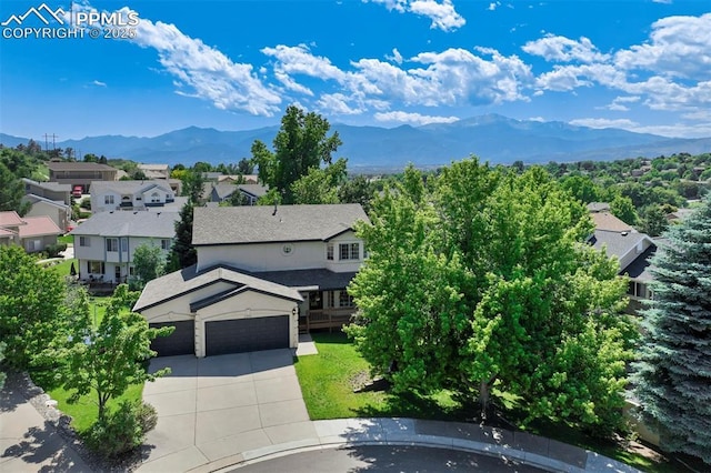 2355 Sawgrass Ct, Colorado Springs, CO 80907 - view of front of house featuring a mountain view, concrete driveway, an attached garage, and a residential view
