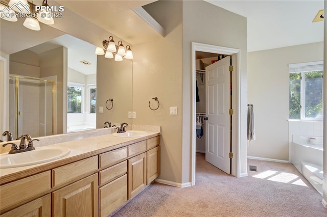 2355 Sawgrass Ct, Colorado Springs, CO 80907 - bathroom featuring a stall shower, a garden tub, double vanity, and a spacious closet