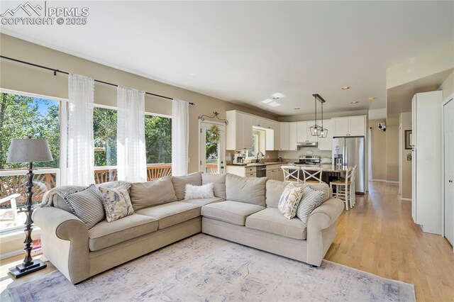 2355 Sawgrass Ct, Colorado Springs, CO 80907 - living room with light wood finished floors and recessed lighting