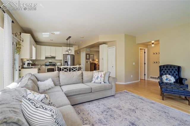 2355 Sawgrass Ct, Colorado Springs, CO 80907 - living room with light wood-style floors and baseboards