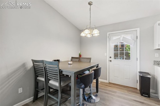 609 Wheat Field Rd, Fountain, CO 80817 - dining room featuring a chandelier, lofted ceiling, and light wood finished floors