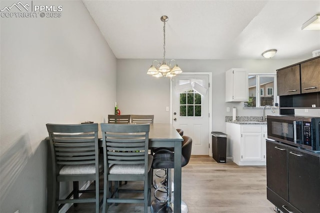 609 Wheat Field Rd, Fountain, CO 80817 - dining space with a chandelier and light wood finished floors