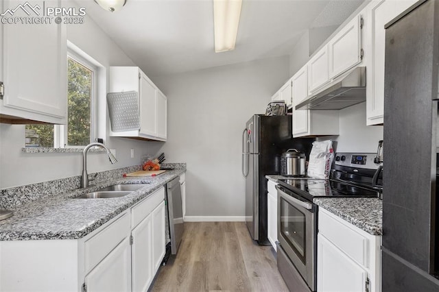 609 Wheat Field Rd, Fountain, CO 80817 - kitchen featuring appliances with stainless steel finishes, under cabinet range hood, light wood-type flooring, and white cabinetry