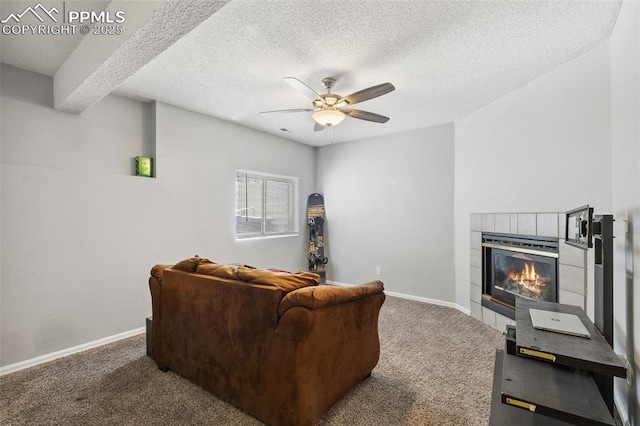 609 Wheat Field Rd, Fountain, CO 80817 - living area with carpet floors, ceiling fan, a tile fireplace, and a textured ceiling