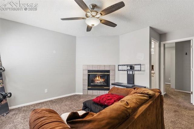 609 Wheat Field Rd, Fountain, CO 80817 - living area featuring carpet floors, a tile fireplace, ceiling fan, and a textured ceiling