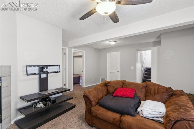 609 Wheat Field Rd, Fountain, CO 80817 - living room with carpet flooring, stairs, ceiling fan, and a textured ceiling