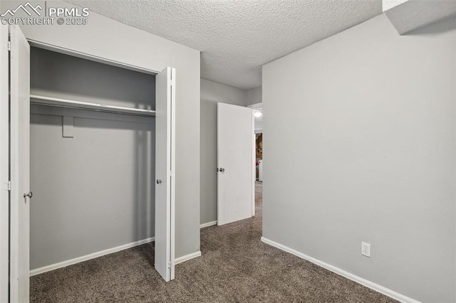 609 Wheat Field Rd, Fountain, CO 80817 - unfurnished bedroom with carpet, a closet, and a textured ceiling