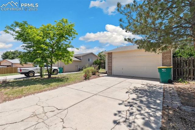 609 Wheat Field Rd, Fountain, CO 80817 - view of front of house with brick siding, driveway, and an attached garage
