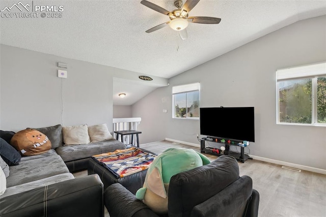 609 Wheat Field Rd, Fountain, CO 80817 - living area with vaulted ceiling, a ceiling fan, wood finished floors, and a textured ceiling