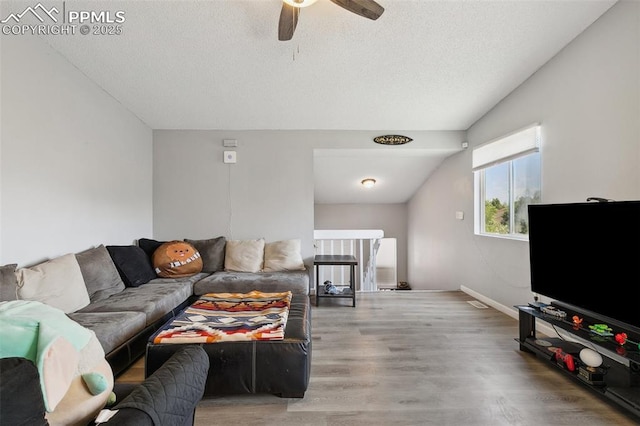 609 Wheat Field Rd, Fountain, CO 80817 - living area with lofted ceiling, ceiling fan, wood finished floors, and a textured ceiling