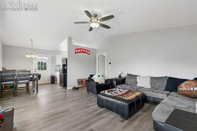 609 Wheat Field Rd, Fountain, CO 80817 - living area featuring a ceiling fan, light wood-type flooring, lofted ceiling, and a chandelier