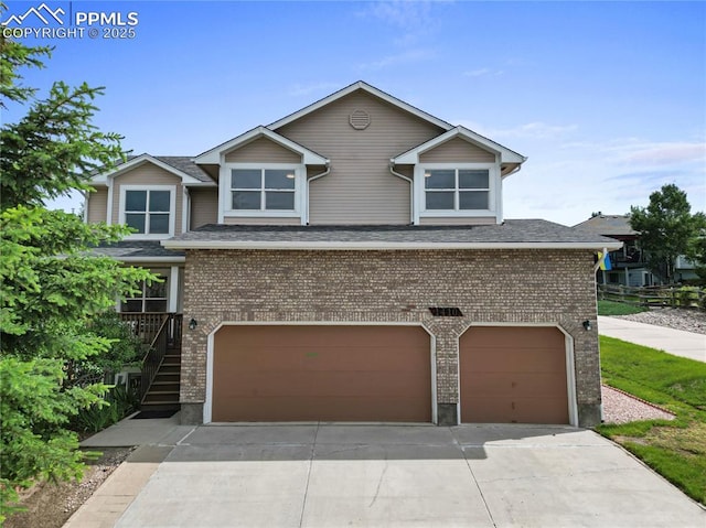 1410 Almagre Peak Dr, Colorado Springs, CO 80921 - view of front facade featuring a garage, brick siding, and concrete driveway