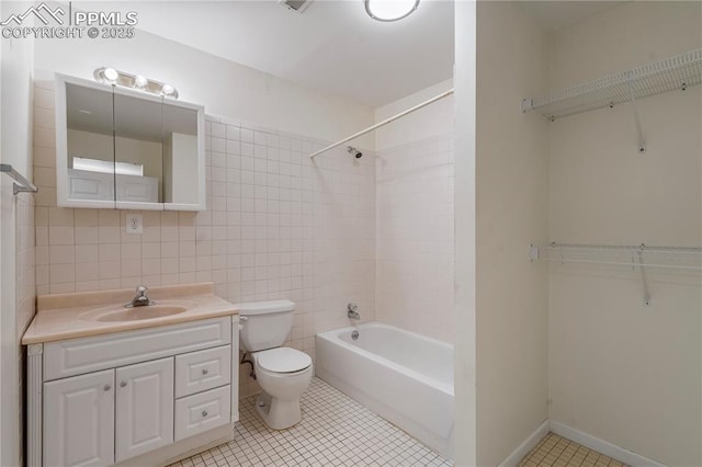 1410 Almagre Peak Dr, Colorado Springs, CO 80921 - bathroom with vanity, tile patterned flooring, shower / bathtub combination, and tile walls