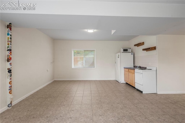 1410 Almagre Peak Dr, Colorado Springs, CO 80921 - kitchen with white appliances and baseboards