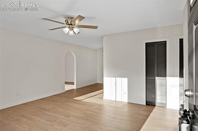 2075 Pepperwood Dr, Colorado Springs, CO 80910 - unfurnished living room featuring arched walkways, ceiling fan, and wood finished floors