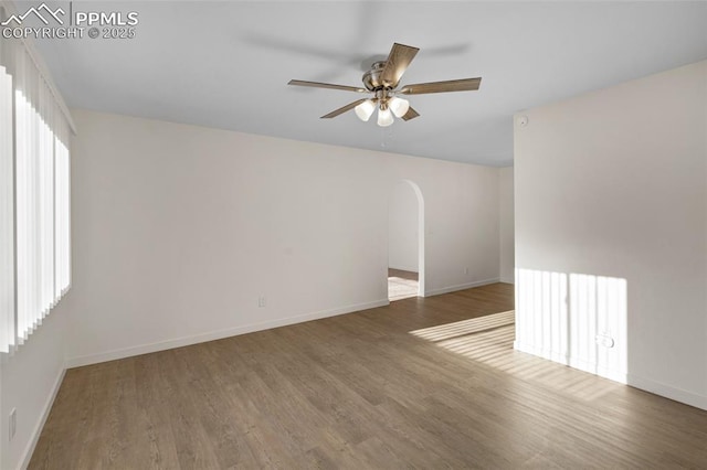 2075 Pepperwood Dr, Colorado Springs, CO 80910 - spare room featuring a ceiling fan, wood finished floors, and arched walkways