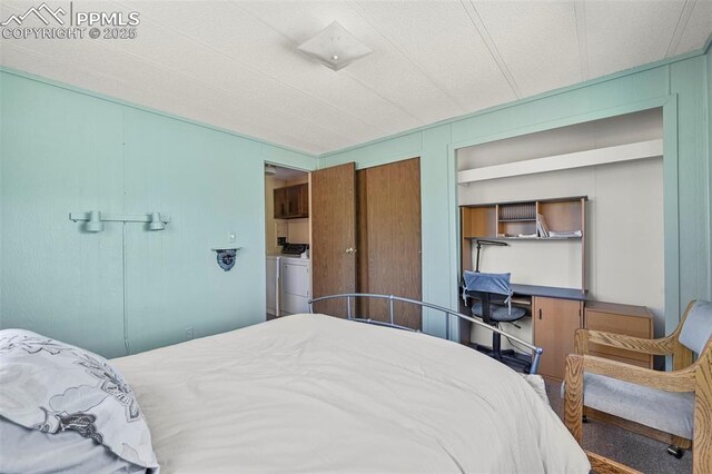 332 Valley Cir, Guffey, CO 80816 - bedroom featuring washing machine and clothes dryer and a decorative wall