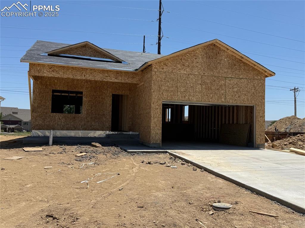 5216 Gannet Ln, Pueblo, CO 81008 - property in mid-construction featuring an attached garage and concrete driveway