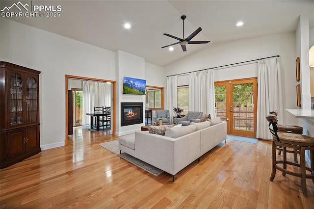 225 Laclede Ct, Colorado Springs, CO 80905 - living area with light wood finished floors, a ceiling fan, french doors, a glass covered fireplace, and recessed lighting